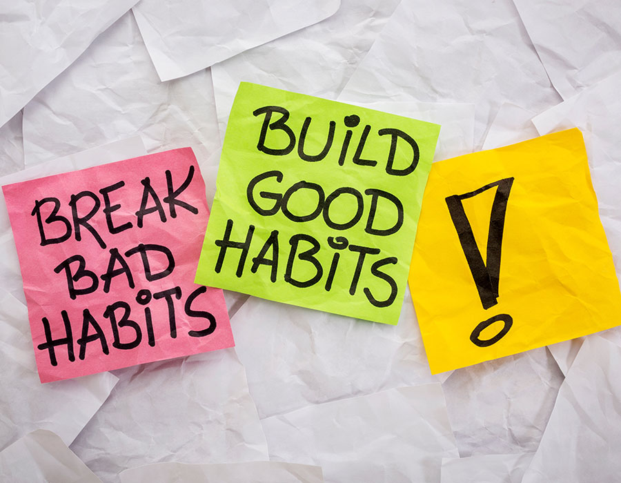 Break bad habits, build good habits - motivational reminder on colorful sticky notes