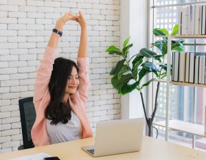 Business woman work from home and stretching her body because feel tired after working on tablet computer, Lifestyle woman relax after working at home concept.